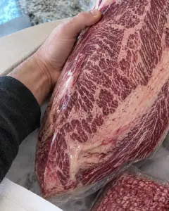 Brisket lifted out of the shipping cooler